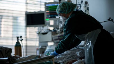 A health care and nursing assistant stands in the Covid-19 intensive care unit at Essen University Hospital, Germany. 