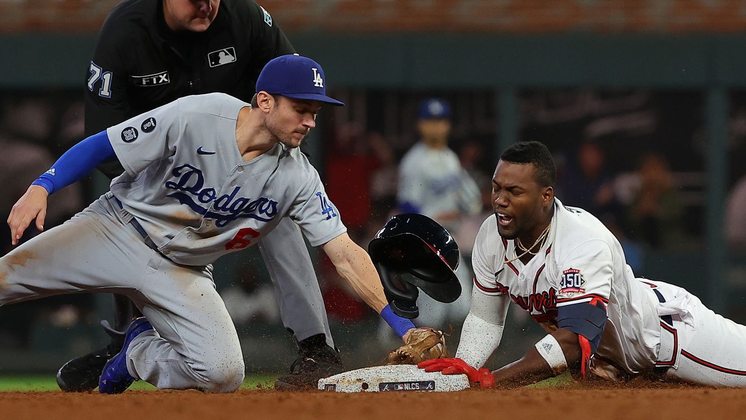 Jorge Soler of the Atlanta Braves beats a tag at second base by Trea Turner of the Los Angeles Dodgers during the eighth inning of Game Six of the National League Championship Series at Truist Park on October 23, 2021 in Atlanta, Georgia.