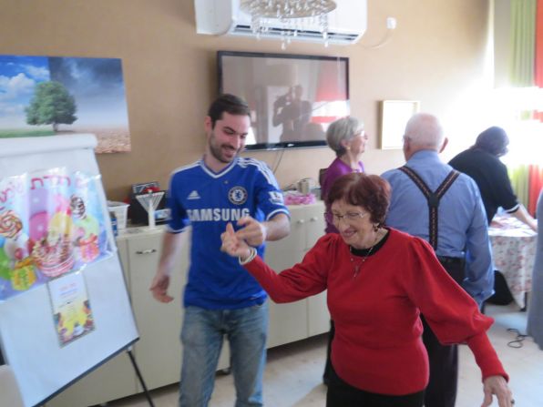 Celebrating life -- The Chelsea Israeli supporters celebrating Hanukkah (Jewish festival of lights) with holocaust survivors in 2019. Just before the pandemic, members of the Israeli supporter's club joined this yearly event hosted by "AMCHA," an organization that provides social and mental support for Holocaust survivors in Israel. The Chelsea fans presented the 'Say No to Antisemitism" campaign and its focus videos on Holocaust survivors. They spoke about the role of football in promoting tolerance and diversity and made a generous donation to the AMCHA organization. They livened up the party by bringing the traditional "sufganiya" (doughnut) pastry and dancing with the survivors. A fun time was had by all.