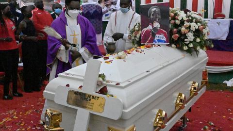 A Catholic priest sprinkles holy water during the funeral service of long-distance Kenyan runner Agnes Tirop, who was found stabbed to death on October 13. 