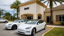 Tesla Model 3 electric vehicles at a Hertz location.