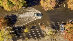 A car crosses a flooded parking lot in Oroville, Calif., on Monday, Oct. 25, 2021. A massive storm barreled toward Southern California on Monday after causing flooding across the northern half of the state. (AP Photo/Noah Berger)