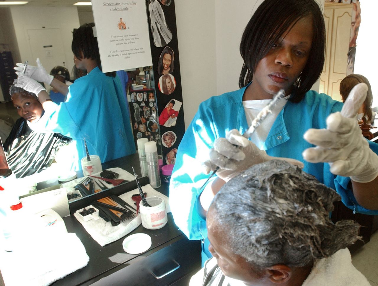 A cosmetology class in progress at Metro State Prison in Atlanta, where inmates practice hairdressing.