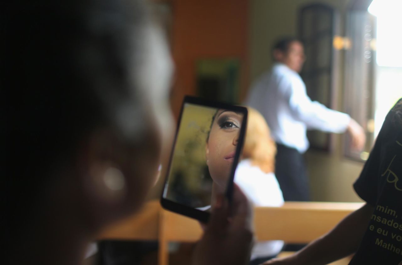 An inmate in Brazil double-checks her beauty look before competing in a beauty pageant at the Talavera Bruce Women's Prison in 2015.