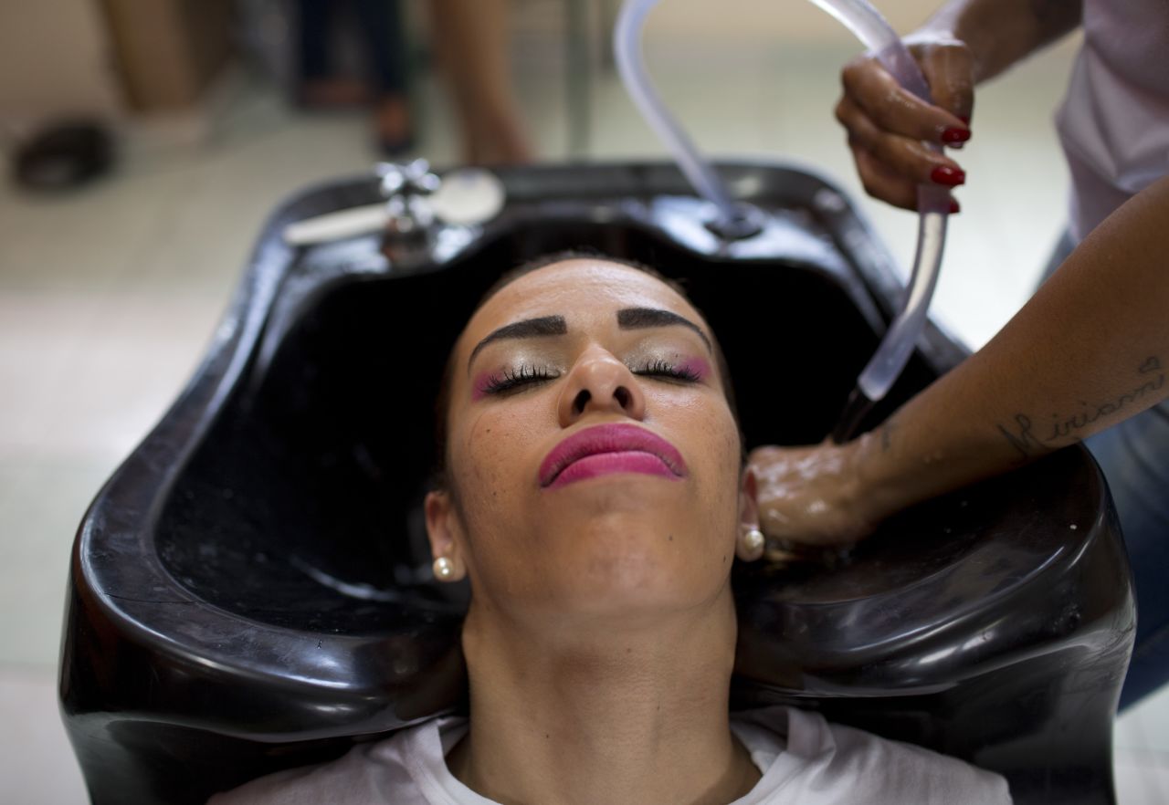 An inmate has her hair washed as she prepares to compete in the 13th annual Miss Talavera Bruce beauty pageant at the penitentiary the pageant is named for, in Rio de Janeiro, Brazil in 2018.