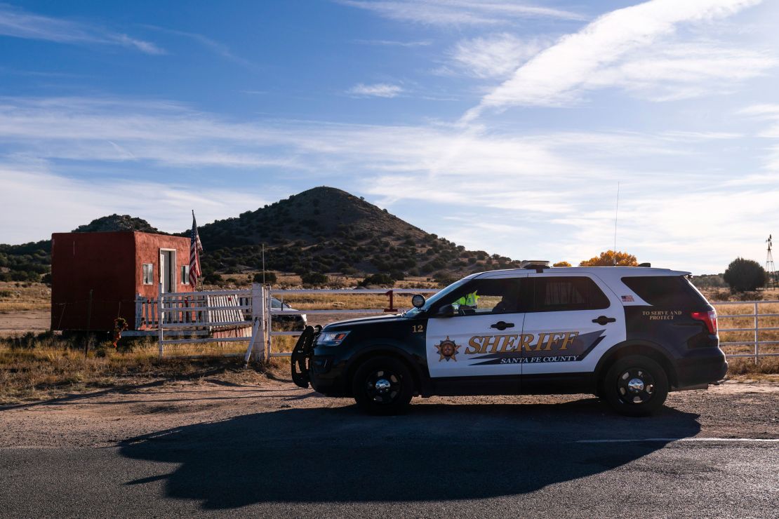 A Santa Fe County Sheriff's deputy talks to  a security guard at the entrance to the Bonanza Creek Ranch in Santa Fe, N.M.