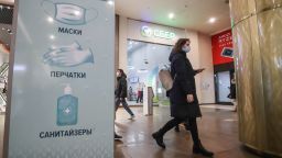 A sign calling on customers to protect themselves by using face masks, gloves and hand sanitiser, at the Galereya shopping and leisure centre in St. Petersburg on Oct. 21, 2021. 