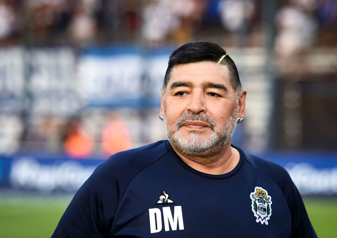 Maradona looks on before a match between Gimnasia y Esgrima La Plata and Velez.