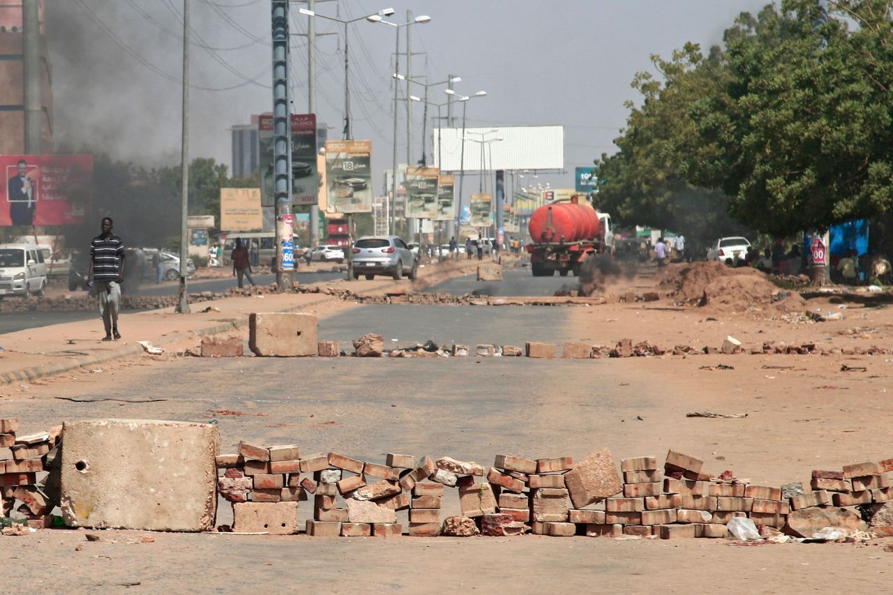 Brick roadblocks set up by protesters are seen on a street in Khartoum on October 26.
