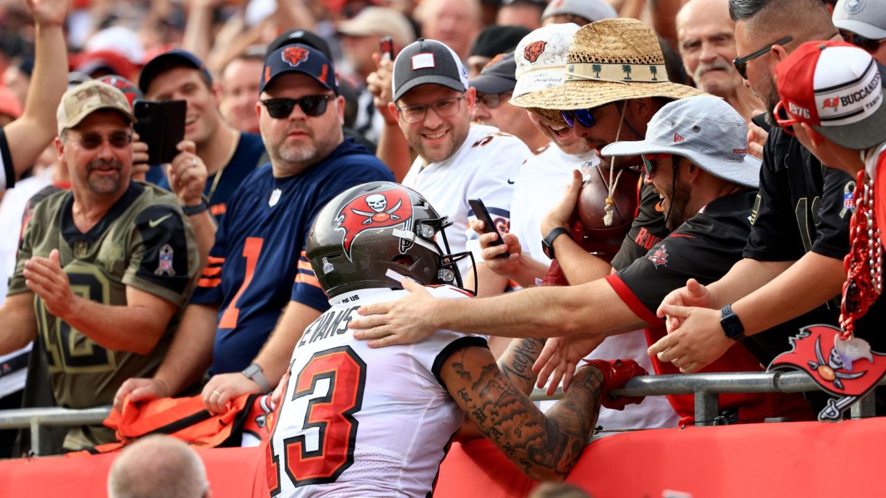 Evans gives a game ball to a fan after scoring a touchdown against the Chicago Bears. 