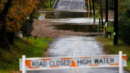 A barricade blocks access to a road flooded by recent rain in Branchburg, N.J., Tuesday, Oct. 26, 2021. 
