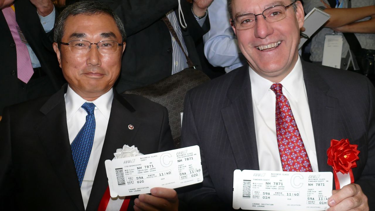 ANA's Shinichiro Ito and Boeing's Scott Faucher with their boarding passes for the inaugural flight. 