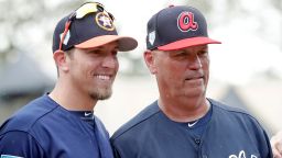 Houston Astros hitting coach Troy Snitker, left, stands with his father Braves manager Brian Snitker before a spring baseball exhibition game, Monday, March 4, 2019, in Kissimmee, Fla. No matter how this year's World Series ends, a Snitker will get a championship ring.  This edition of the Fall Classic is a family affair with Atlanta Braves manager Brian Snitker in the dugout opposite his son, Houston Astros co-hitting coach Troy Snitker. 