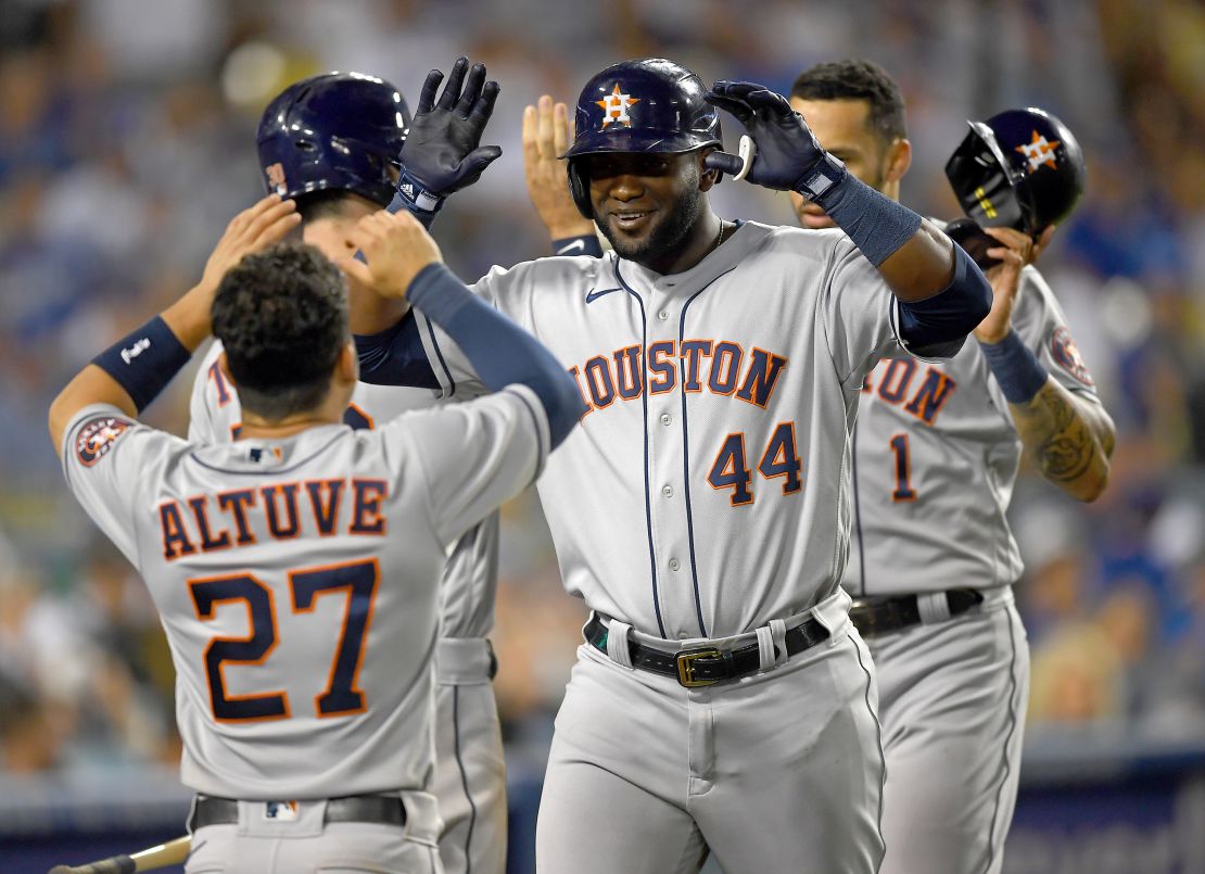 Yordan Alvarez is greeted by Jose Altuve after hitting a two-run home run against the Los Angeles Dodgers.