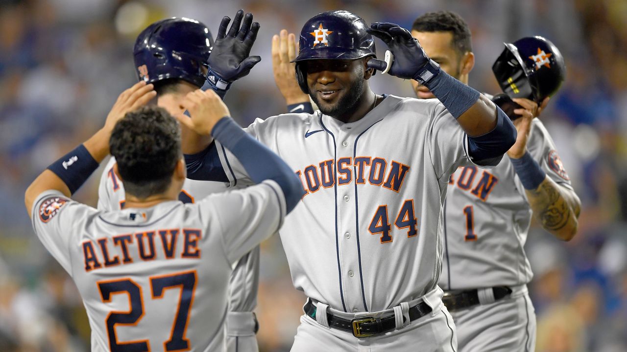 Yordan Alvarez is greeted by Jose Altuve after hitting a two-run home run against the Los Angeles Dodgers.