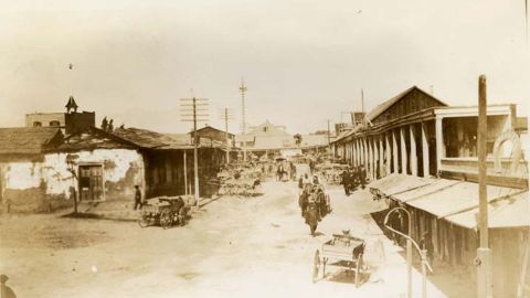 Calle de Los Negros, the area of Los Angeles where the 1871 Chinese massacre unfolded, is depicted as it looked in the late 19th century.