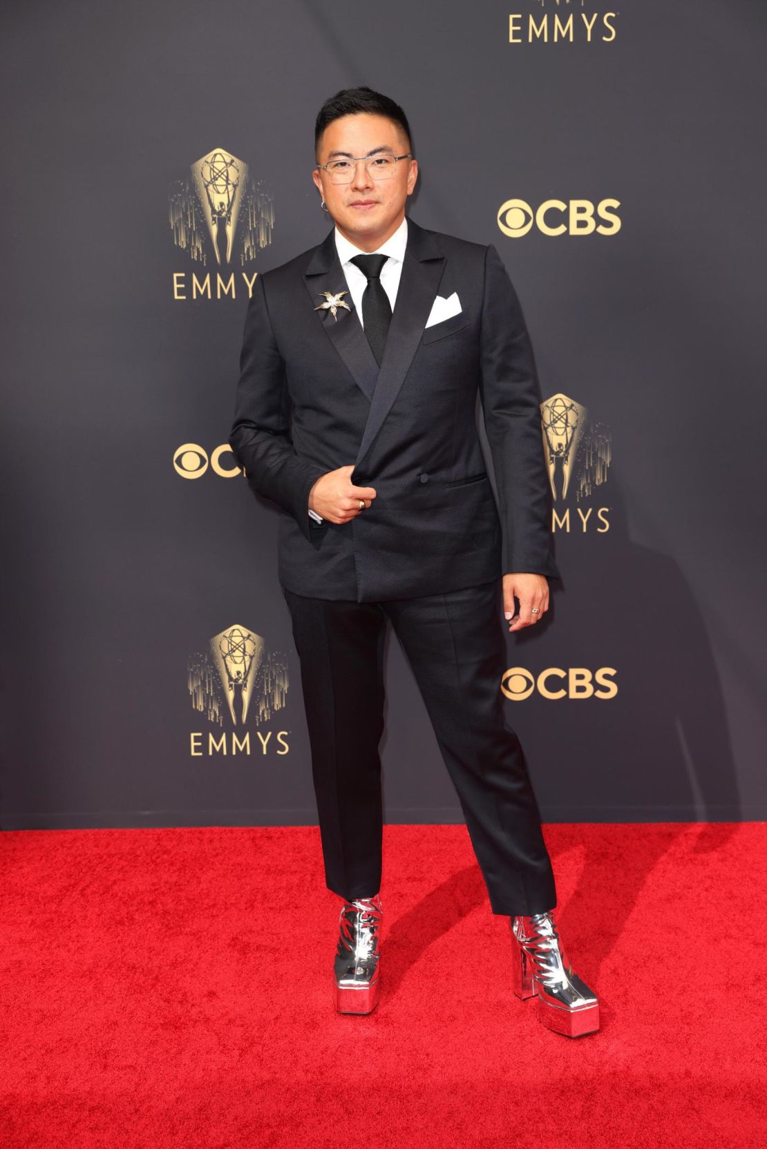 "Saturday Night Live" star Bowen Yang wears Syro silver platform heels to the 2021 Emmy Awards. 