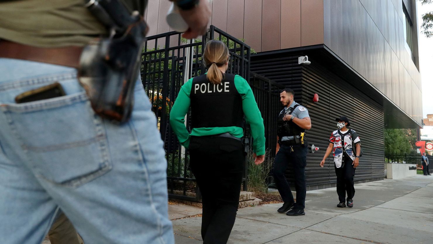 Chicago police officers arrive at the Fraternal Order of Police local lodge on Wednesday, Oct. 13, 2021 before a meeting on the city's vaccine mandate for employees.