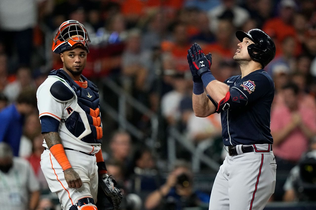 Astros catcher Martin Maldonado stands at home plate as the Braves' Adam Duvall celebrates after a two-run home run during the third inning of Game 1.