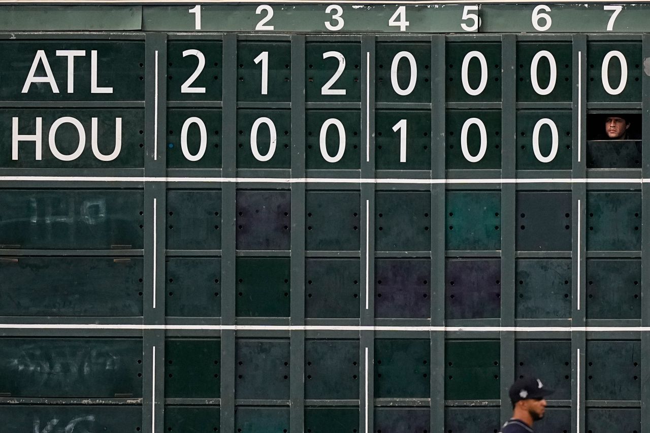 A scoreboard worker watches during the seventh inning of Game 1.