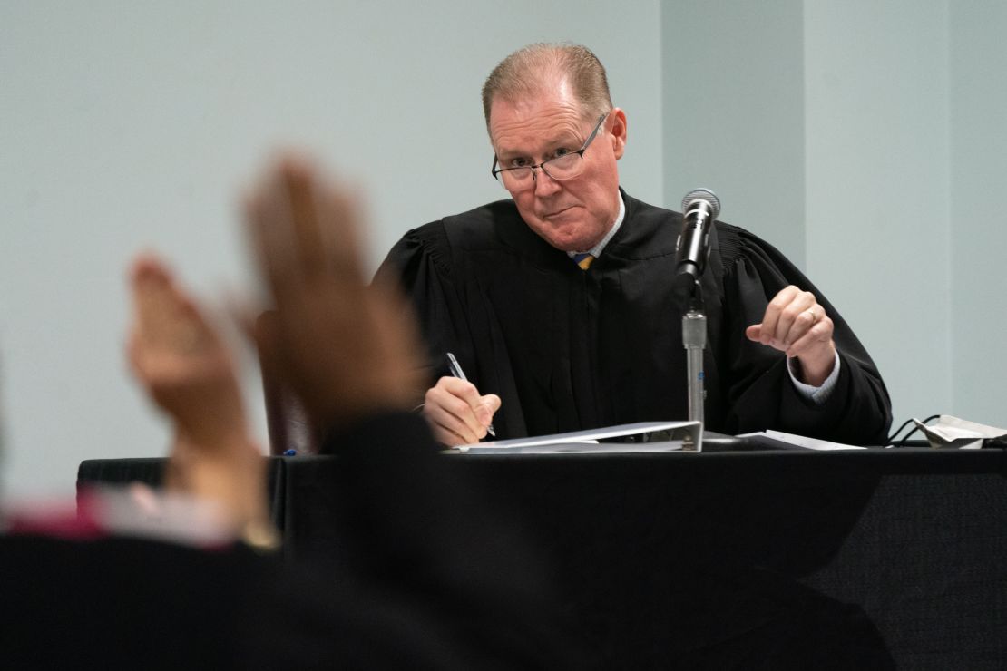 Judge Timothy Walmsley administers the oath to potential jurors during jury selection on October 26, 2021, in Brunswick, Georgia.