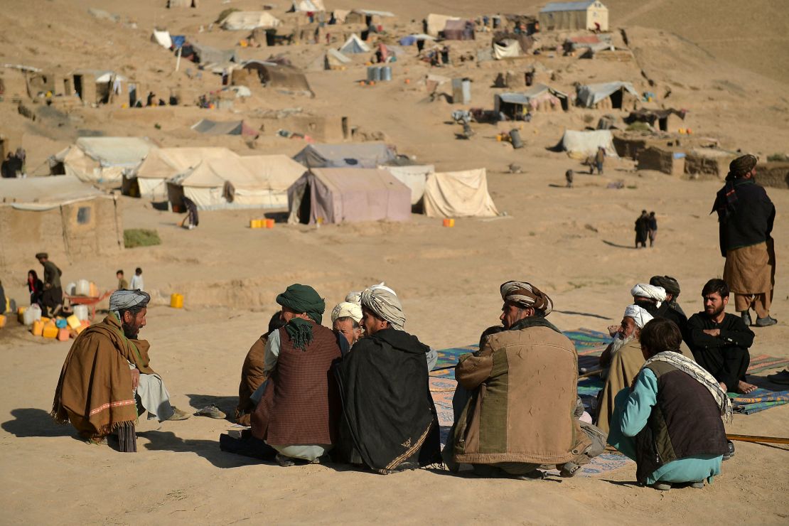 Men sitting at a camp for internally displaecd people in Qala-i-Naw, Badghis province, on October 17.
