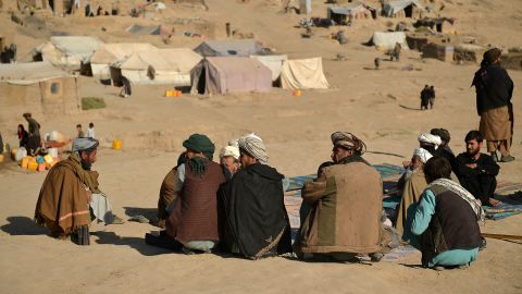 Men sitting at a camp for internally displaecd people in Qala-i-Naw, Badghis province, on October 17.
