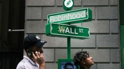NEW YORK, NEW YORK - JULY 29: People wait in line for t-shirts at a pop-up kiosk for the online brokerage Robinhood along Wall Street after the company went public with an IPO earlier in the day on July 29, 2021 in New York City. Robinhood Markets Inc. shares fell about 5% during its Nasdaq debut. (Photo by Spencer Platt/Getty Images)