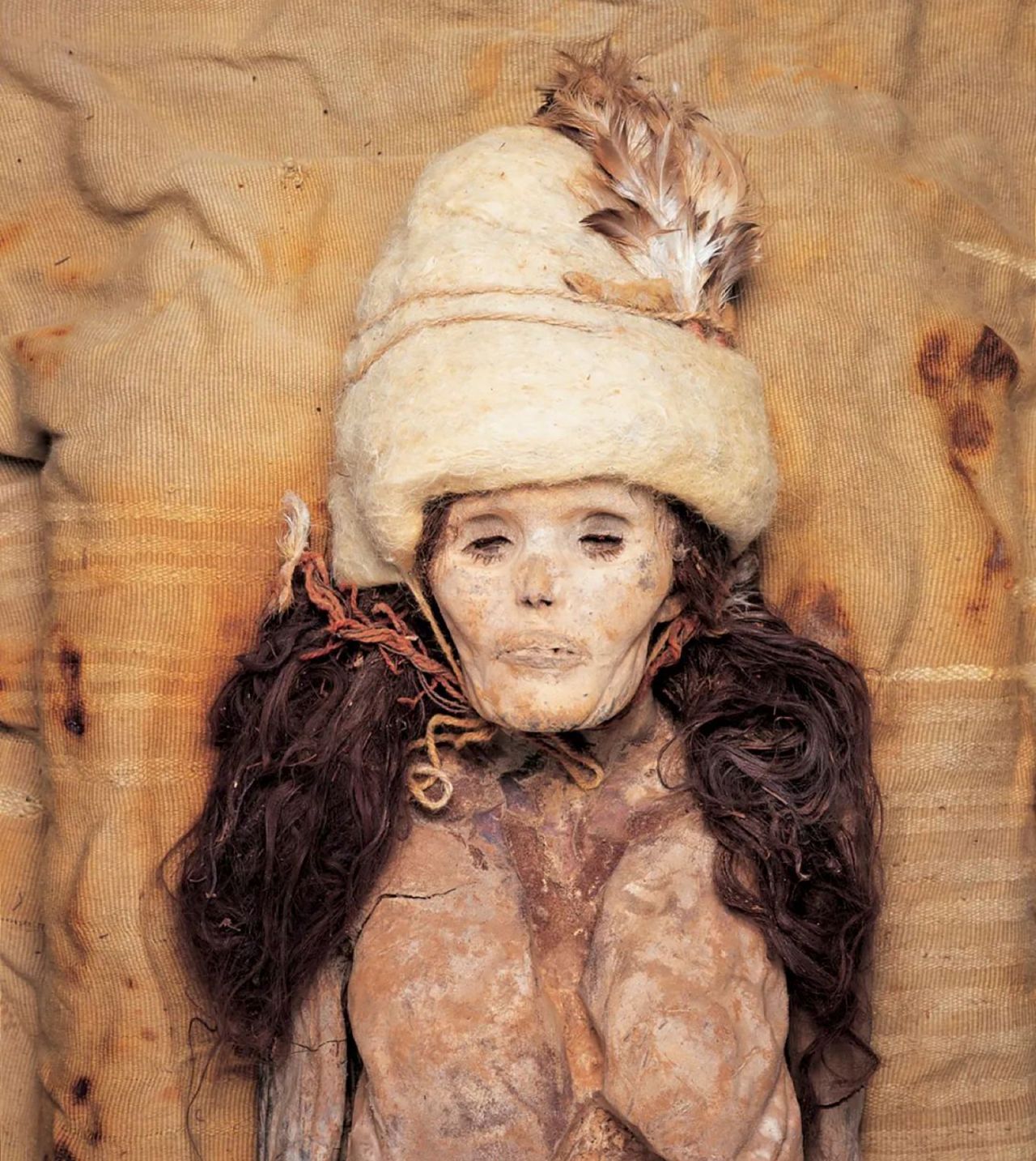 The dry desert air means the bodies are extraordinarily preserved, with hair and facial features clearly visible.