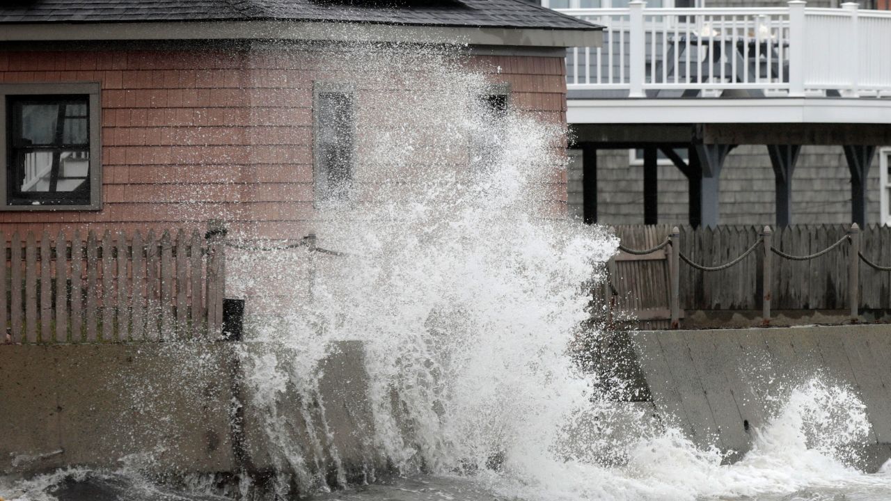 A wave crashes Tuesday into the retaining wall of a home in Fairhaven, Massachusetts.