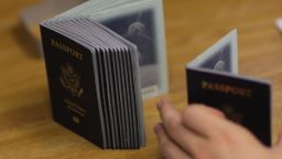 A Passport Processing employee uses a stack of blank passports to print a new one at the Miami Passport Agency June 22, 2007 in Miami, Florida. 