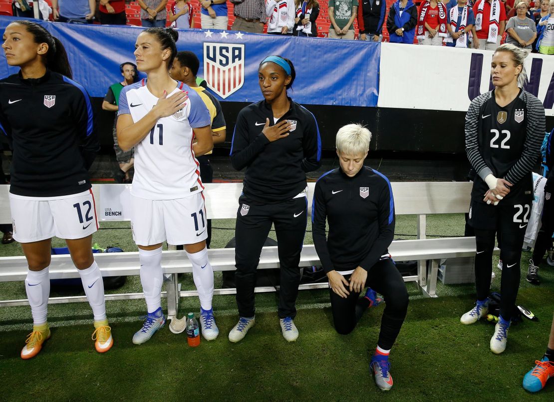 Megan Rapinoe takes a knee.