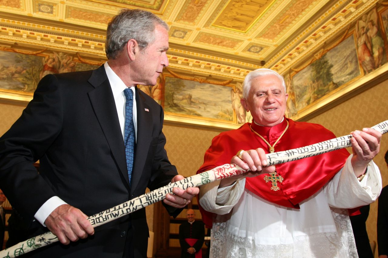 During a trip to the Vatican in 2007, President George W. Bush gives Pope Benedict XVI a walking stick inscribed with the Ten Commandments. The stick was made by a formerly homeless man in Texas. Bush met with popes a record six times while he was in office.