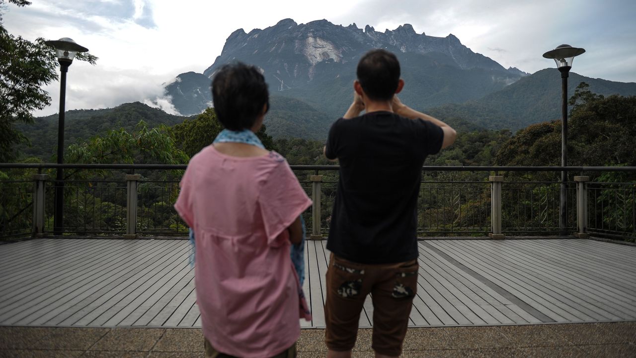 Tourists take photos of Malaysia's Mount Kinabalu in 2015.