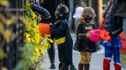 NEW YORK, NY - OCTOBER 31: Children receive treats by candy chutes while trick-or-treating for Halloween in Woodlawn Heights on October 31, 2020 in New York City. The CDC shared on their website alternative ways to still celebrate the holiday while being safe. (Photo by David Dee Delgado/Getty Images)