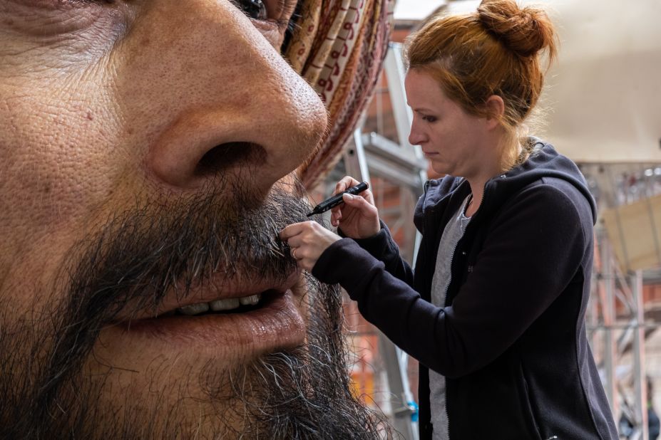 About 20,000 individual holes had to be drilled into the faces to insert the beards. The eyes were made using high-definition 3D printers.
