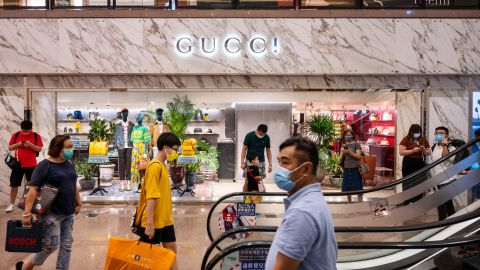 Shoppers walking past a Gucci store in Hong Kong. 