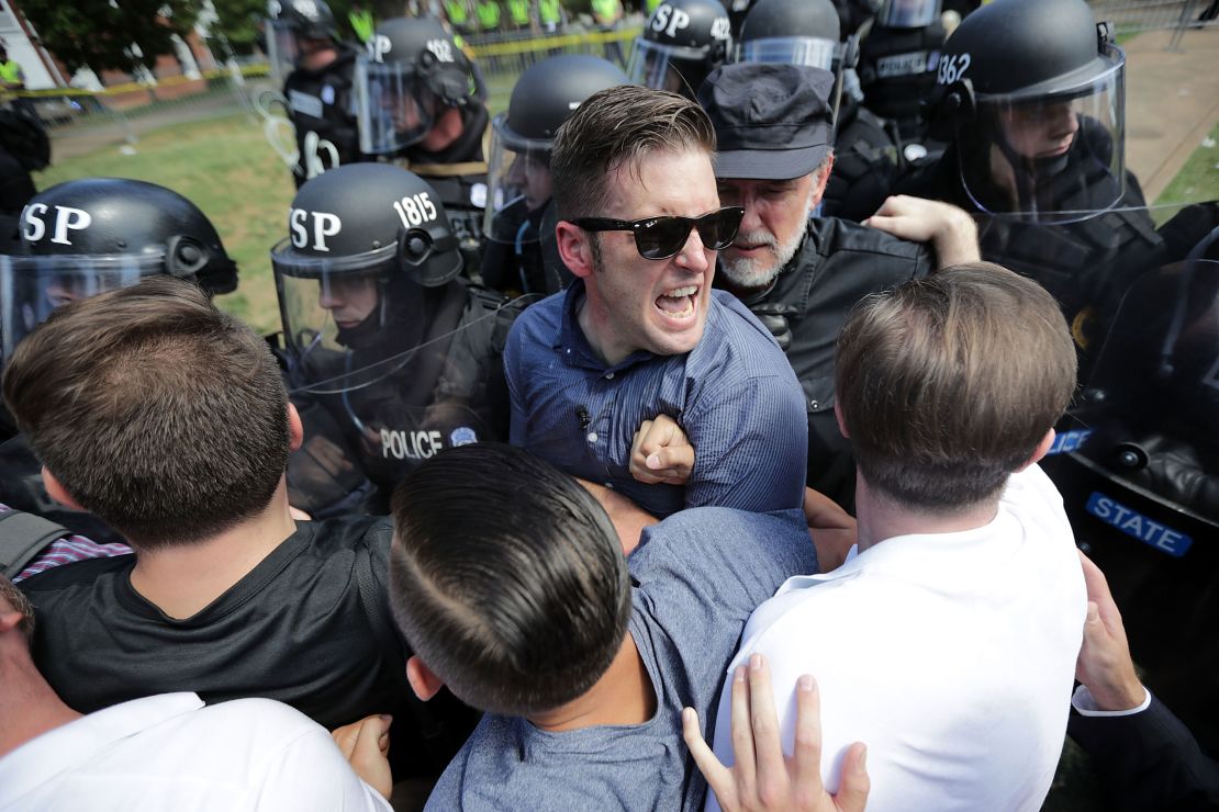 White nationalist Richard Spencer (center) and his supporters clash August 12, 2017, with Virginia State Police in Emancipation Park after the Unite the Right rally  in Charlottesville, Virginia, was declared an unlawful gathering.