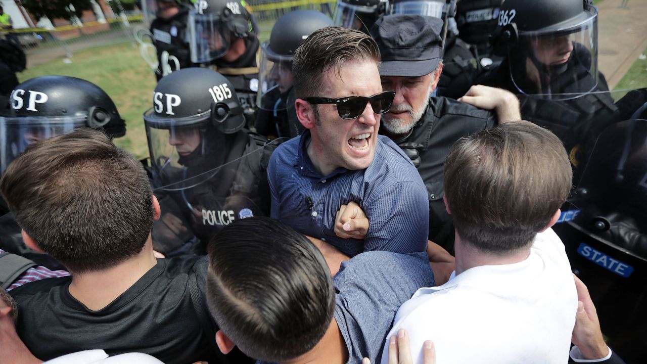 White nationalist Richard Spencer (center) and his supporters clash August 12, 2017, with Virginia State Police in Emancipation Park after the Unite the Right rally  in Charlottesville, Virginia, was declared an unlawful gathering.