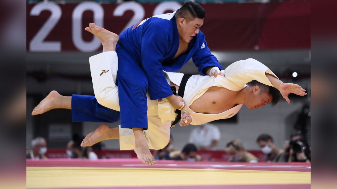 Japan's Hisayoshi Harasawa and South Korea's Kim Minjong compete in the judo men's +100kg elimination round during the Tokyo 2020 Olympic Games.