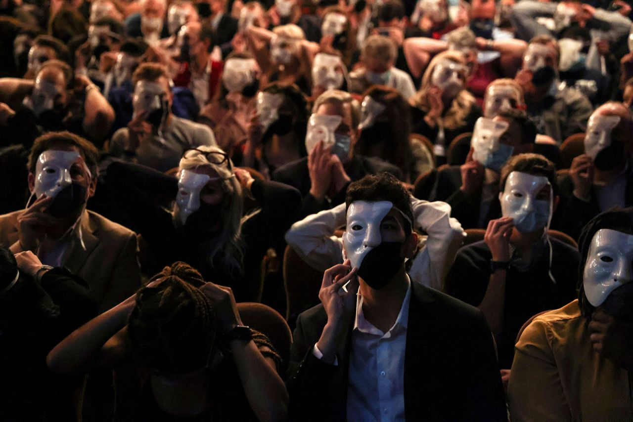 Audience members wear masks at New York's Majestic Theater to mark the Broadway return of "Phantom of the Opera" on Friday, October 22.