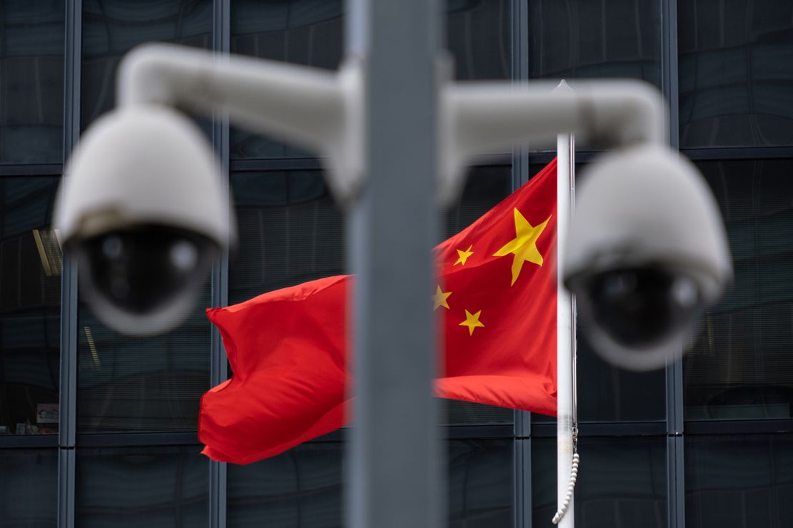 The flag of China is flown behind a pair of surveillance cameras outside the Central Government Offices in Hong Kong.