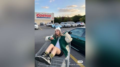 A Chinese influencer poses in the Costco parking lot in Shanghai.
