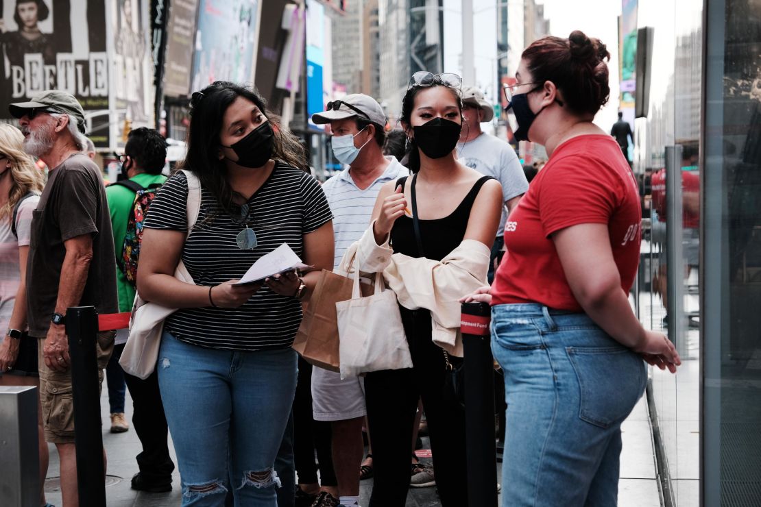 People wear masks on Broadway in New York City last month.