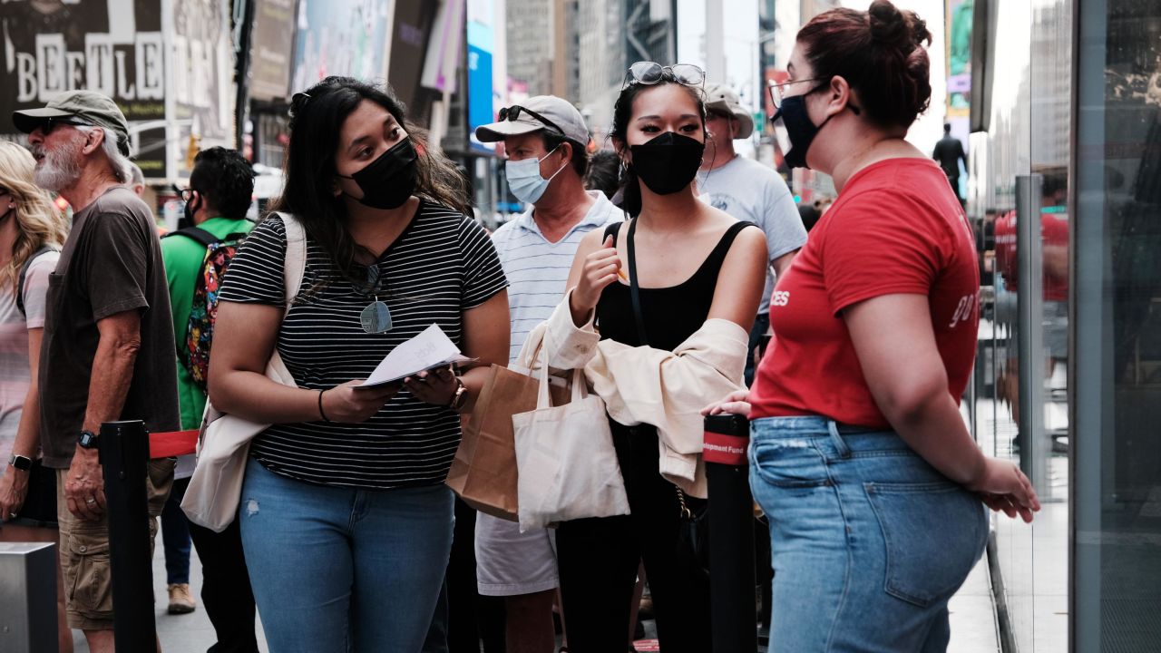 People wear masks on Broadway in New York City last month.