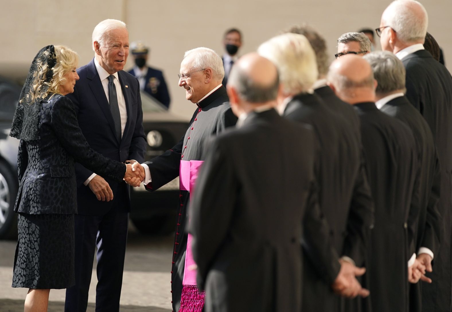 The Bidens are greeted by Monsignor Leonardo Sapienza, the head of the papal household, as they arrive to meet with the Pope.