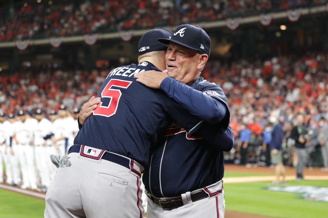 Freddie Freeman of the Atlanta Braves hugs manager Brian Snitker during Game 1 of the 2021 World Series.