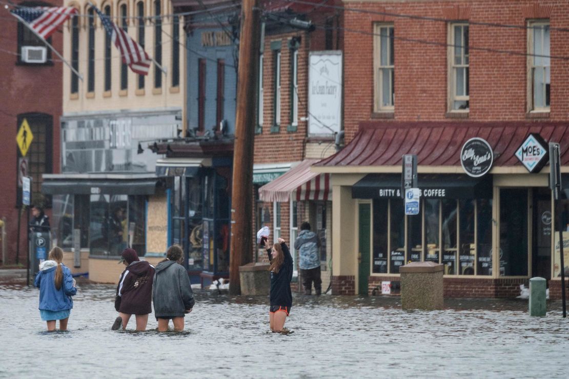 People wade through floodwaters in downtown Annapolis, Maryland, on Friday.