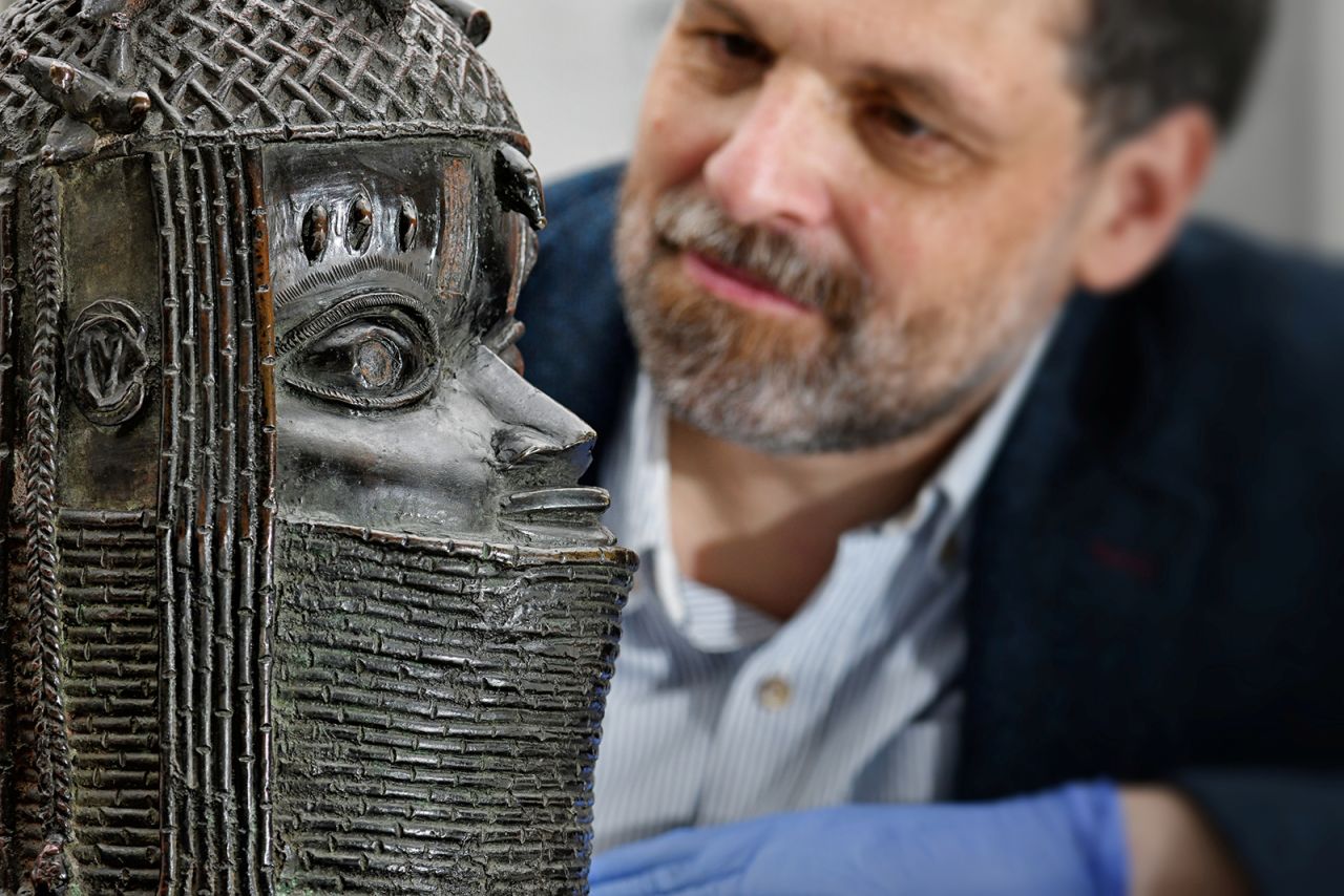 Neil Curtis, head of Museums and Special Collections at the University of Aberdeen, looks at a bronze sculpture depicting an oba (king) of Benin.