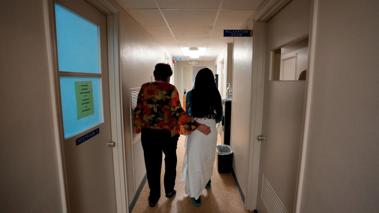 A 33-year-old mother of three from central Texas is escorted down the hall by the clinic administrator prior to getting an abortion, October 9 2021, in Shreveport, Louisiana. 